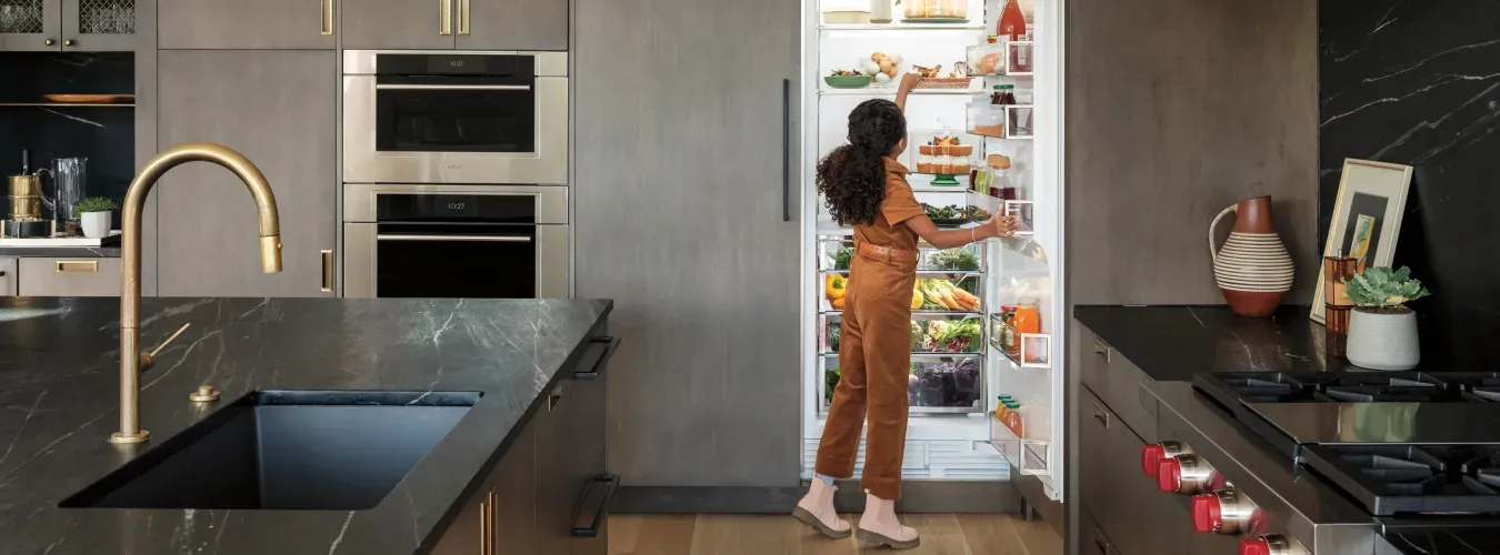 young-girl-reaching-in-sub-zero-open-refrigerator